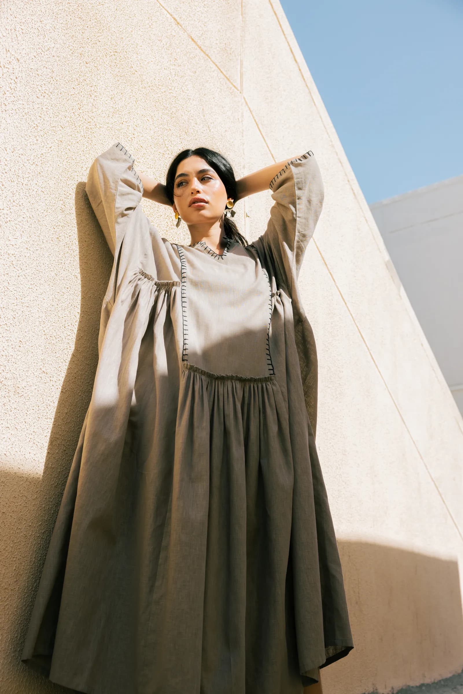 Model in an abaya posing against white walls in Kuwait