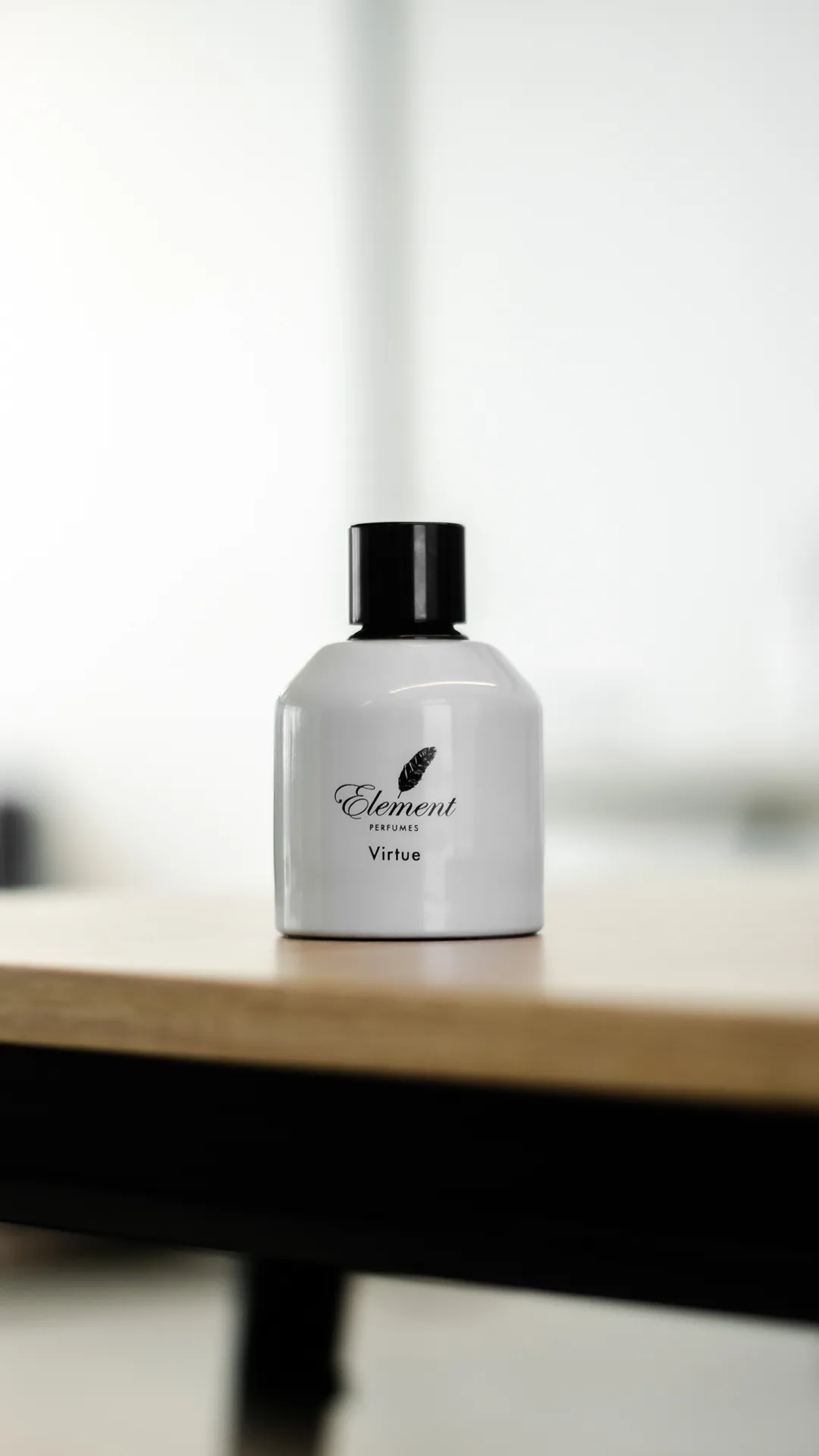 White perfume bottle with a black cap in soft window light