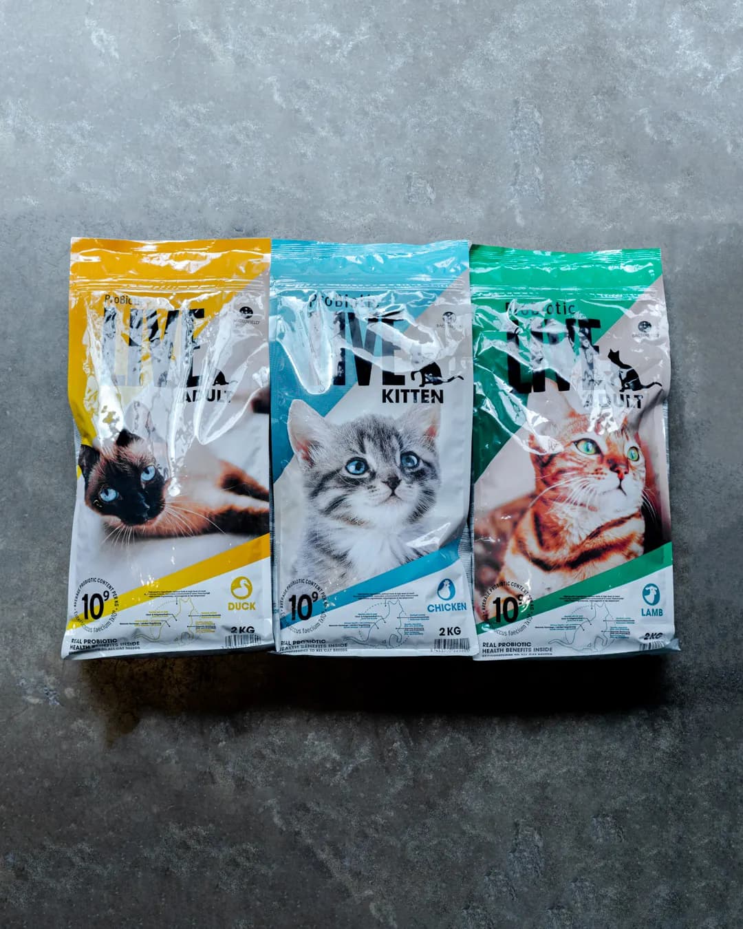 Bags of cat food arranged on a concrete floor